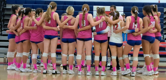 The Girls Varsity team huddles to discuss strategy for the game.