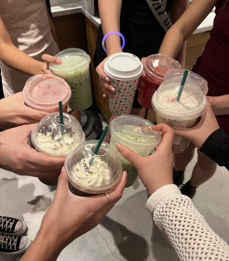 A group of good friends enjoying the holiday Starbucks drinks.