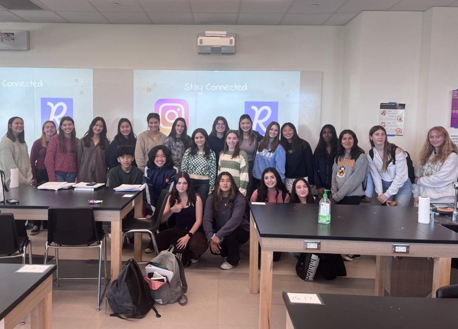 A group photo of the Women in STEM club during a meeting. 