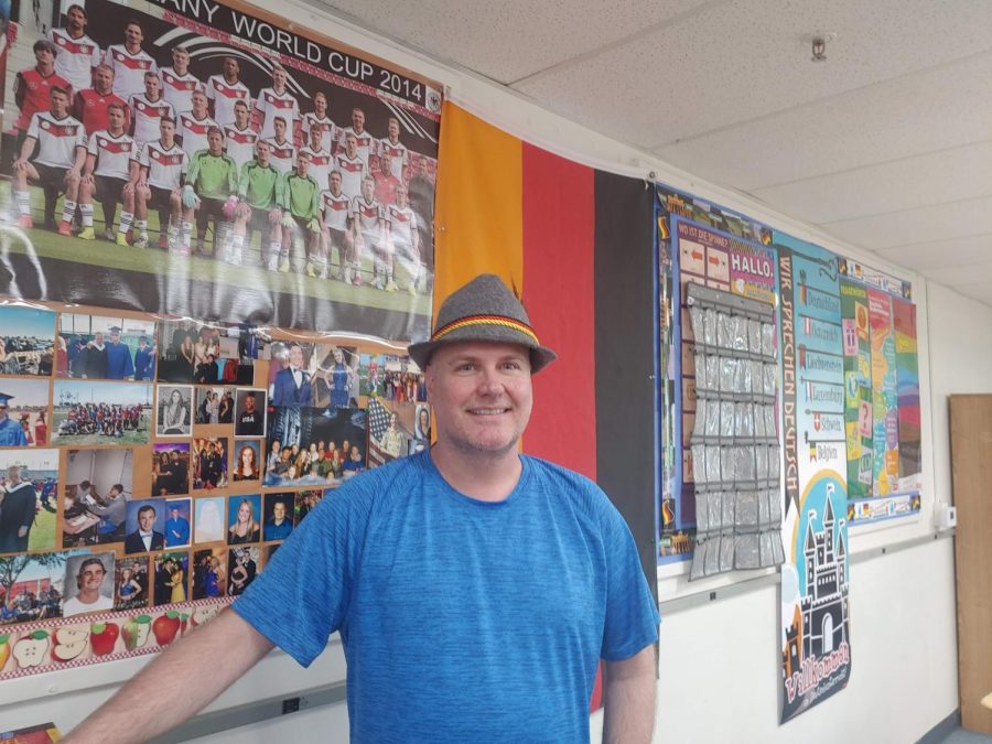Mr. Hooper in front of the German wall in his classroom. 