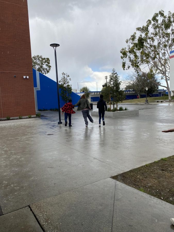 Los Al students run in the rain