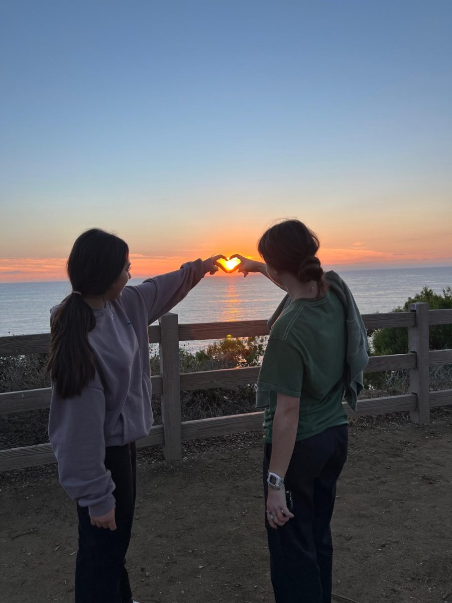 Marina Zeba and Issy Steinberg watching the sunset in Rancho Palos Verdes, California.