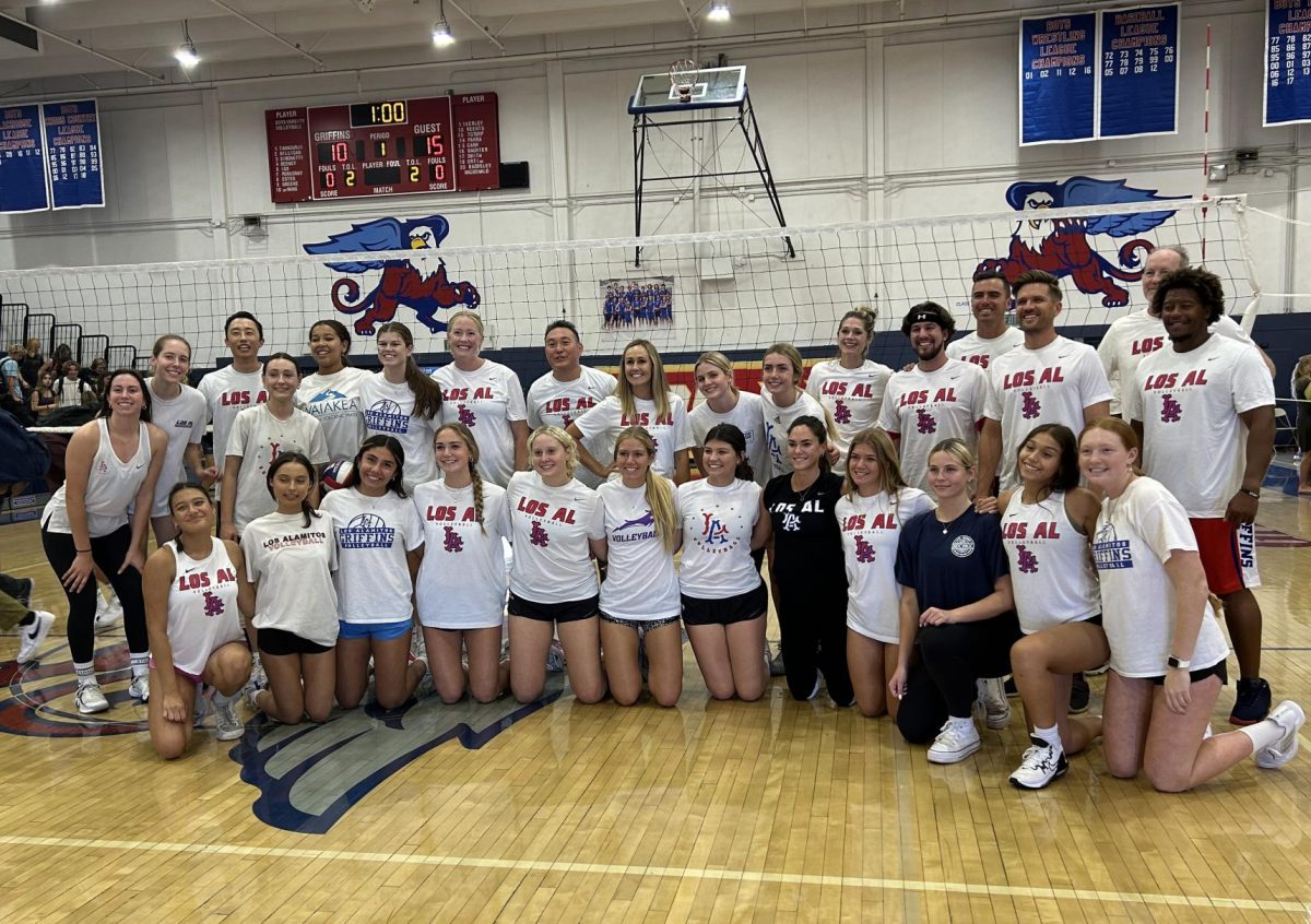 Girls varsity volleyball and the 11 staff players gather for a post-game photo. 