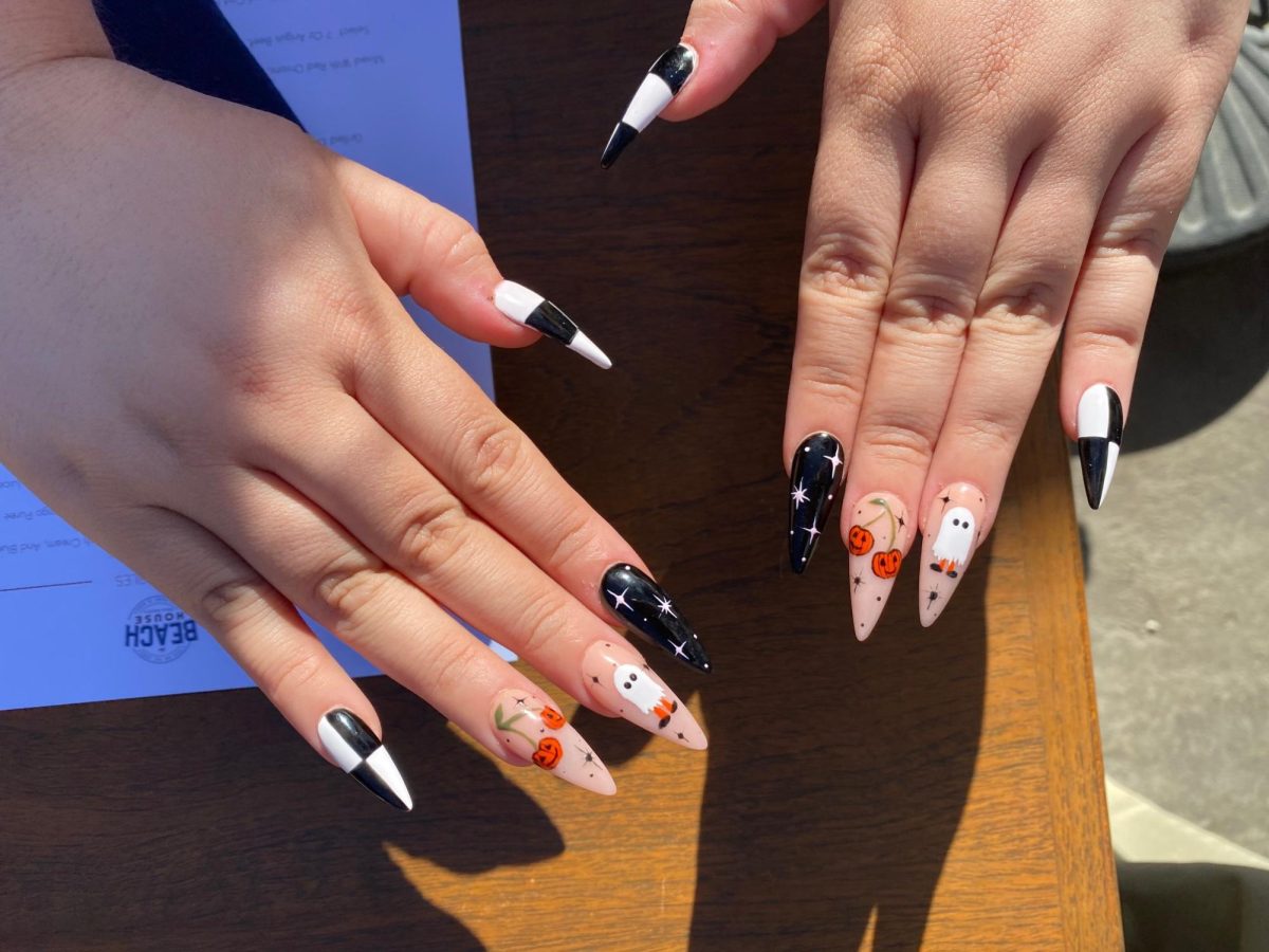These fall themed nails feature black and white checkers, stars, and pumpkin designs.