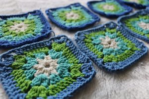 Beautiful green, blue, and white crocheted squares. Courtesy of Unsplash.