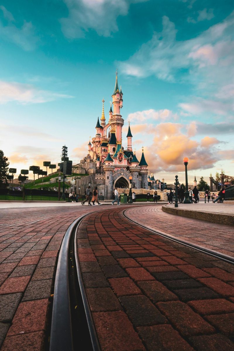 At Disneyland Paris, people walk near Disneyland Castle in the early hours of the morning. 