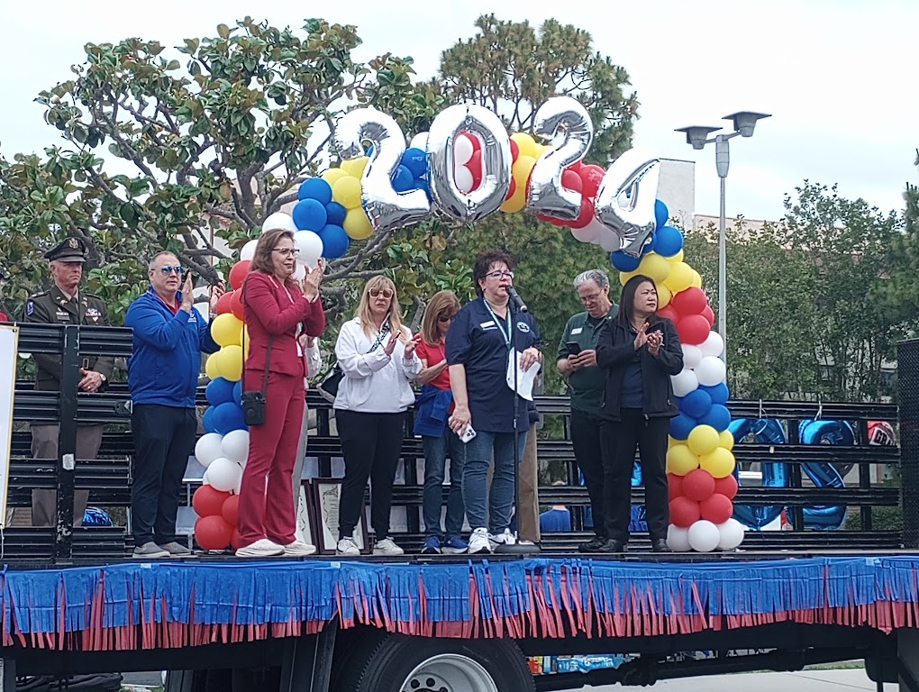 Jo Shade, Second Vice President of the Rossmoor Community Services District, gives opening remarks to the seniors before the parade begins.