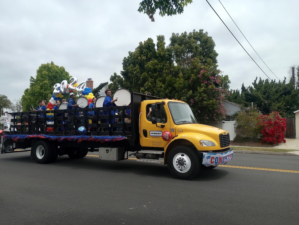 Los Al Drumline members play from the back of a truck as they drive through the parade route.