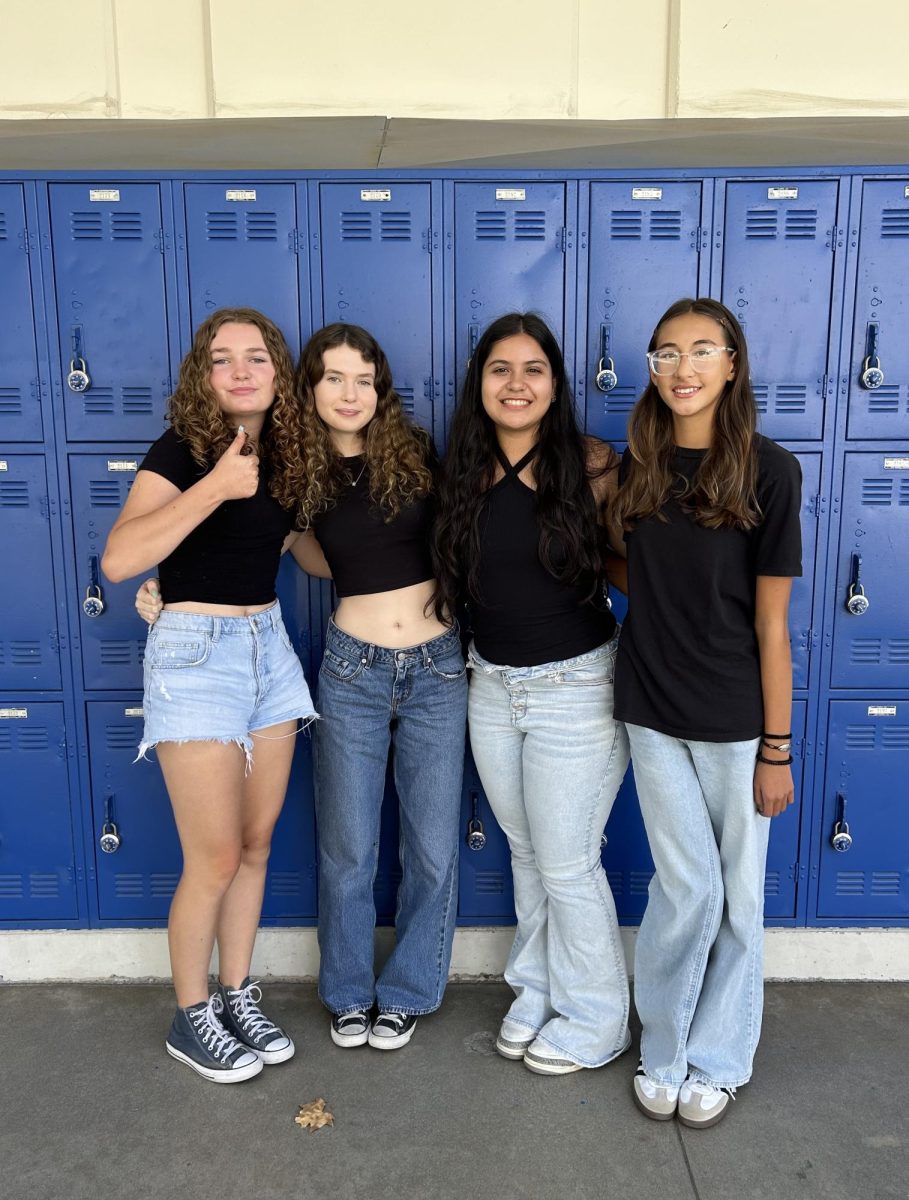 Four journalism students decided to wear jeans and black shirts for twin day.