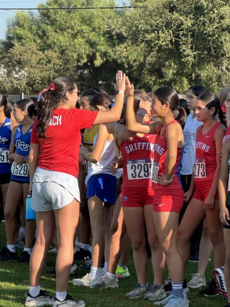 Freshman Mio Emi is congratulated by her coach after her race. (Photo courtesy of Miwa Emi)