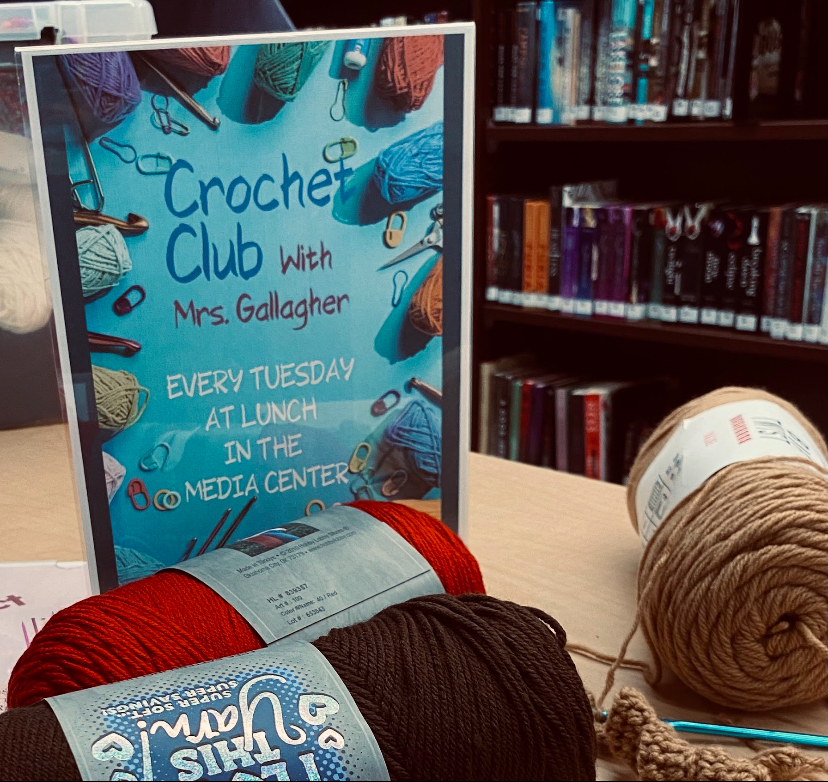 Crochet Club flyers introduce the club alongside skeins of yarn being used for projects.