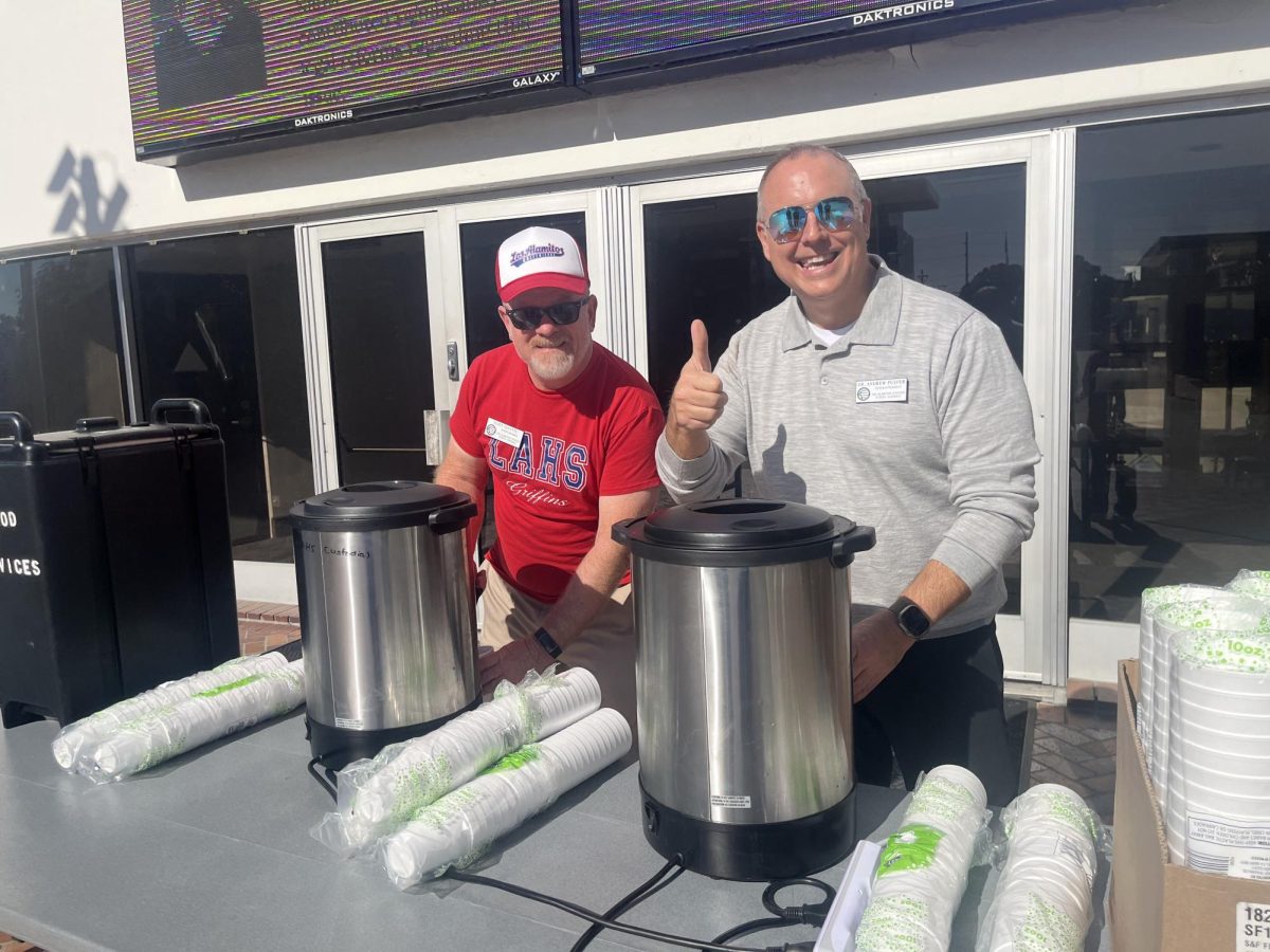 Dr. Pulver and recently retired board member Scott Fayette setting up the hot cocoa station for students. 