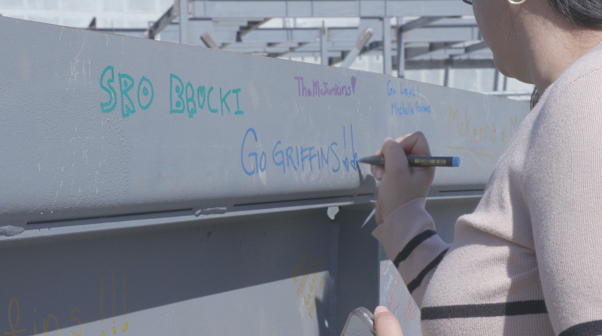 Administrators visit the gym construction site to sign the last beam. (Photo courtesy of Joe Burke)