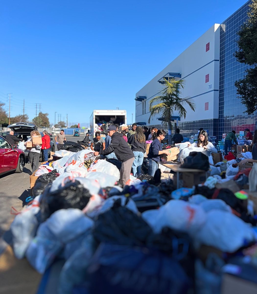 Volunteers unloading, sorting and packing donations for the successful drive.