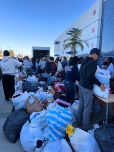 Volunteers work hard to sort donated clothes by size and gender. 