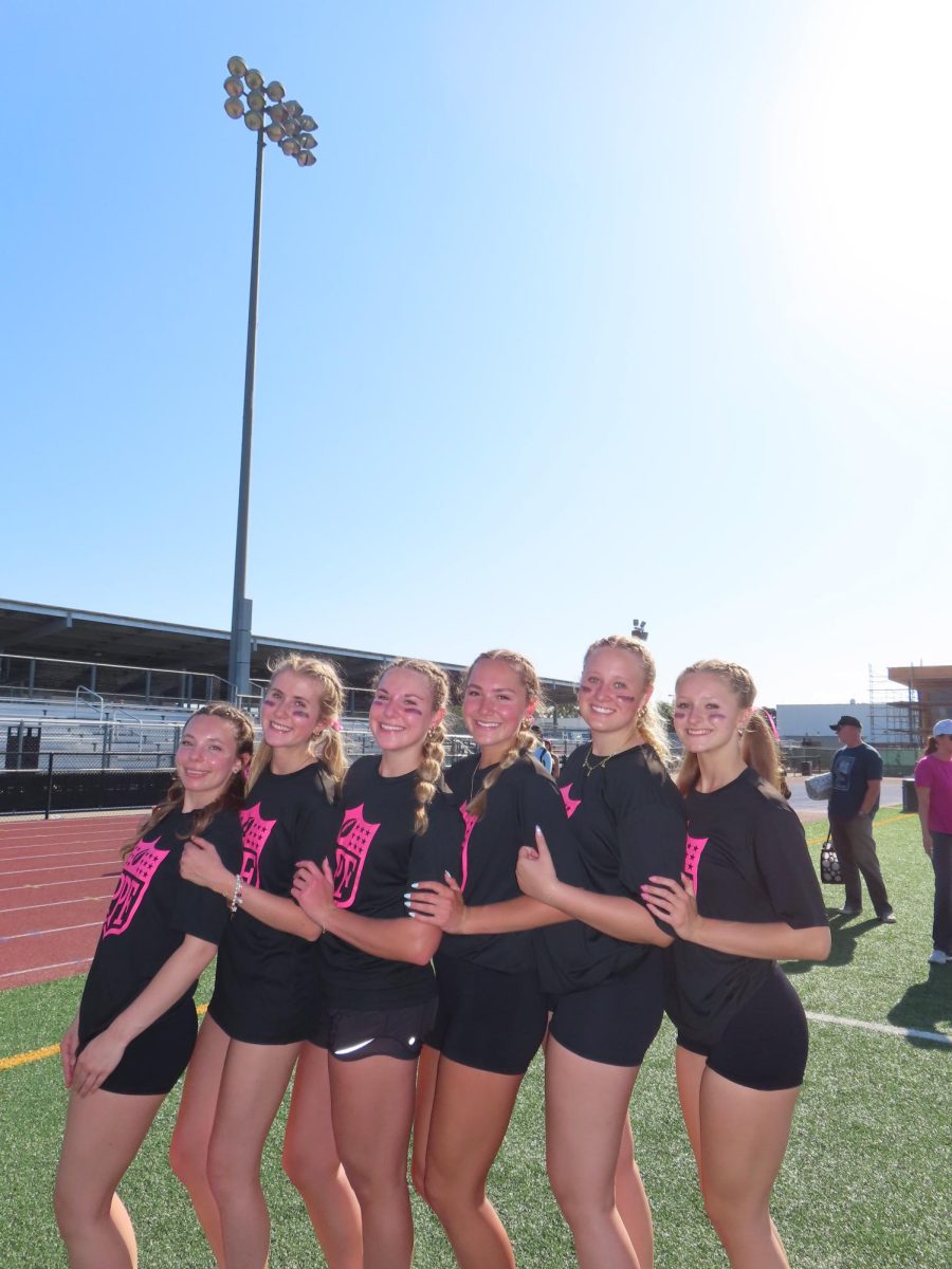 Senior girls excitedly come together before the game, eager to show off on the field. 