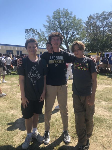 Three students wearing baggy shirts, a popular trend this year. 