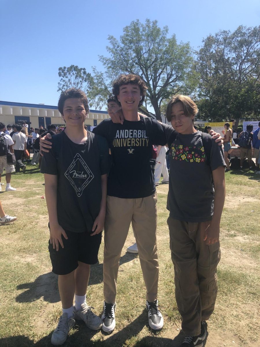 Three students wearing baggy shirts, a popular trend this year. 