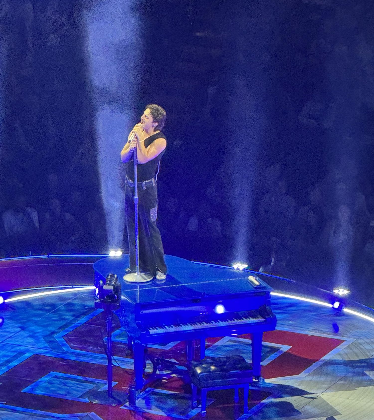 Benson Boone sings "In the Stars" while standing on his piano.