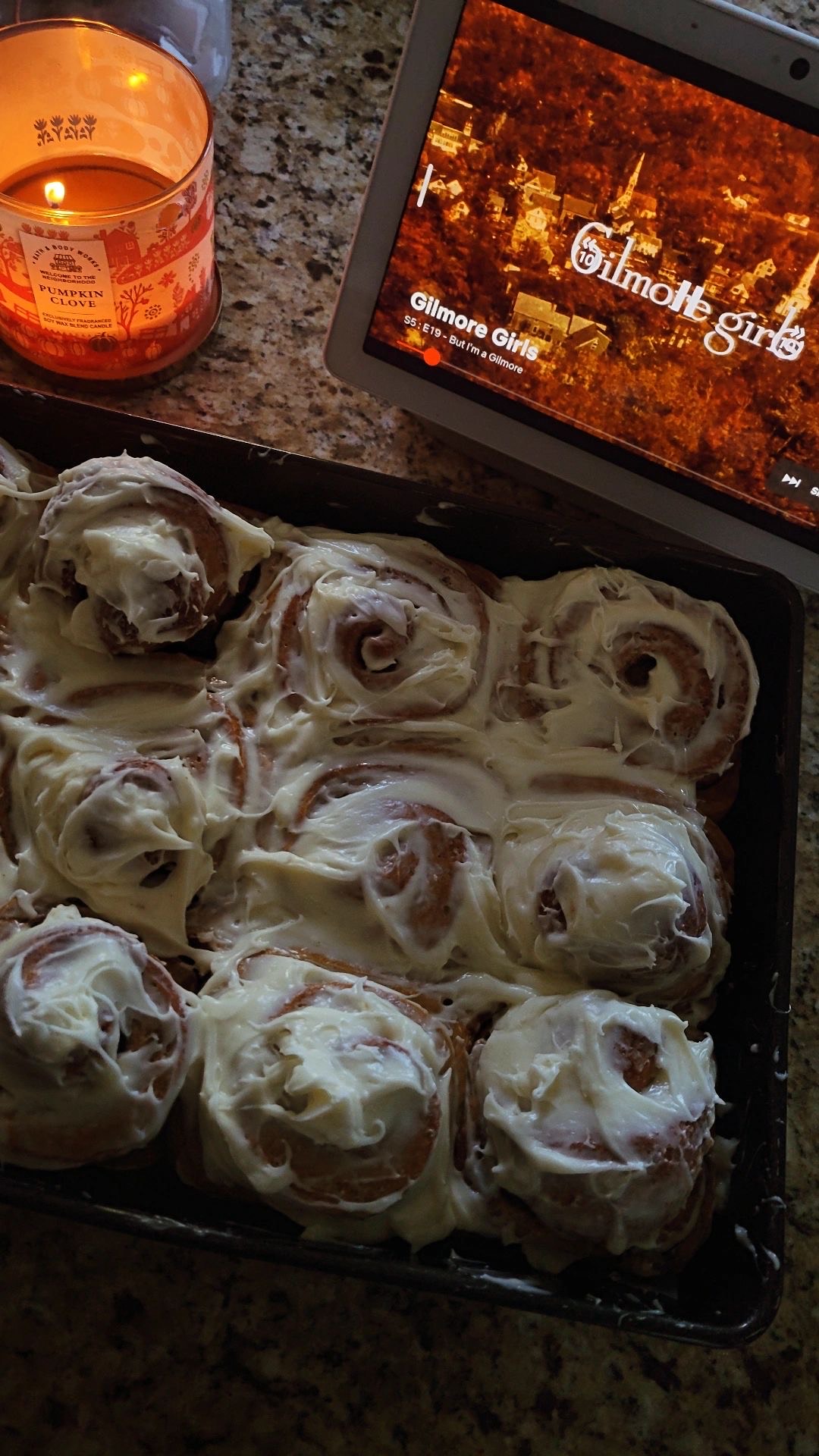 Homemade cinnamon rolls with Gilmore Girls playing in the background.