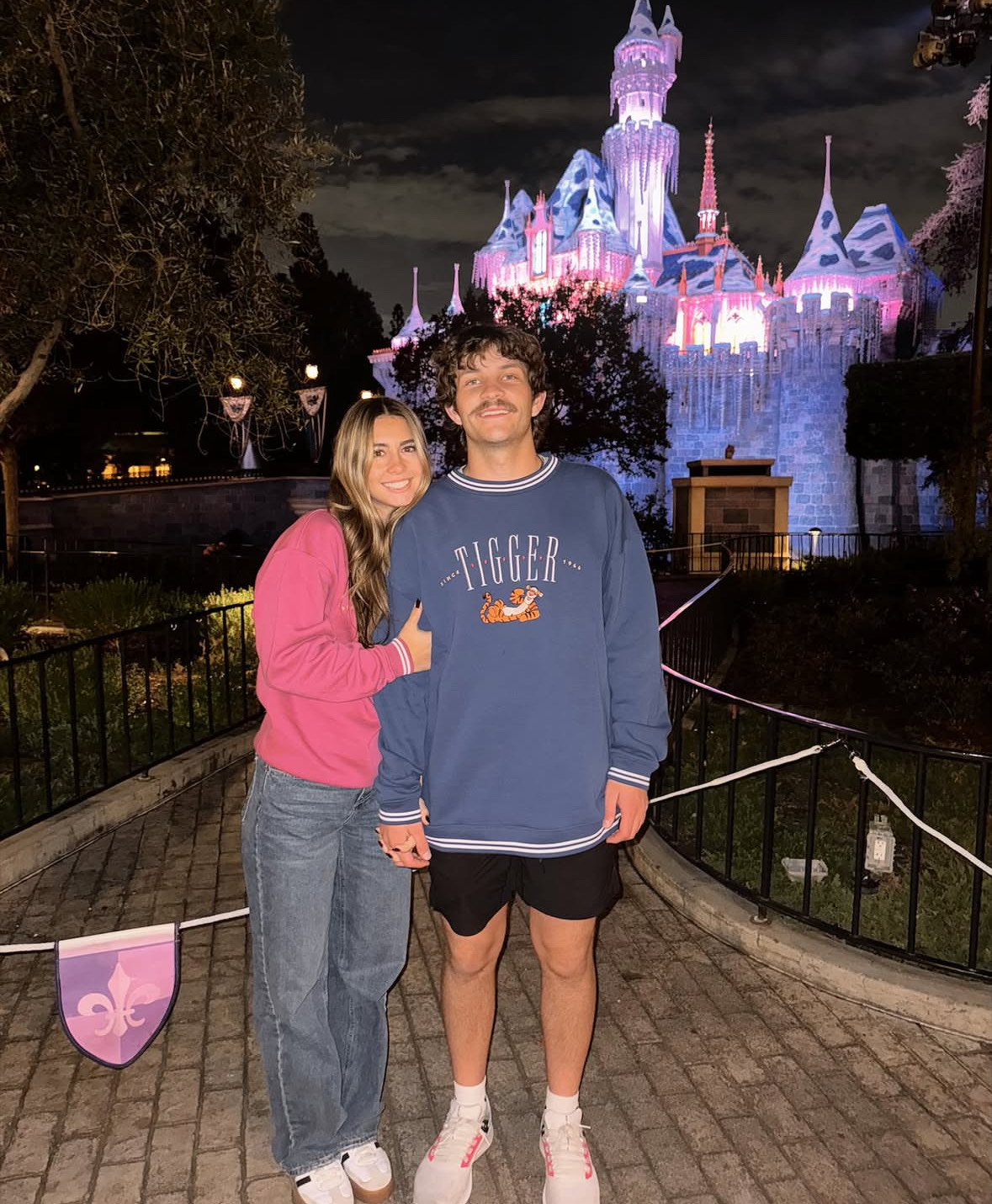 Couple at an amusement park during the spooky season.