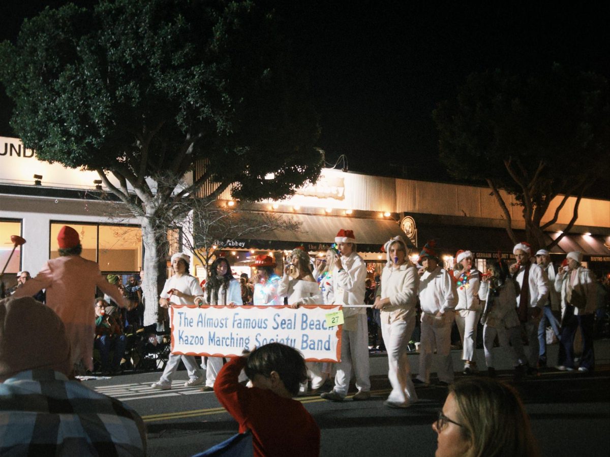 The Almost Famous Seal Beach Kazoo Marching Society Band is an annual favorite, decked out in their matching white ensembles.