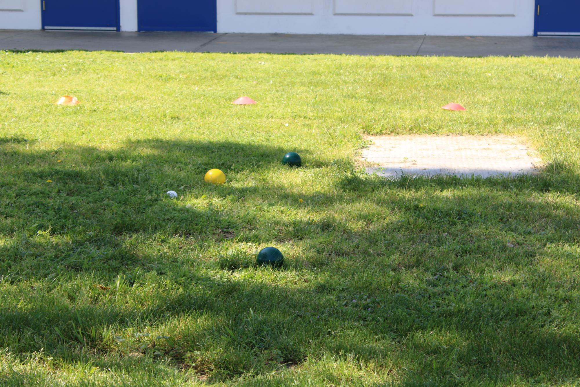 A close game: many students' bocce balls ended up very close to the white target ball.