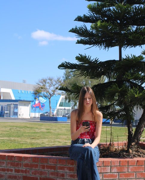 A student too consumed by the digital world to appreciate the nature around them.